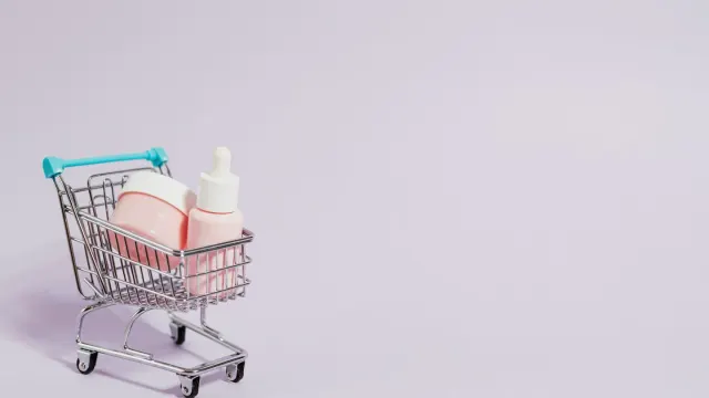 A supplement bottle sitting beside a laptop showing an online checkout screen