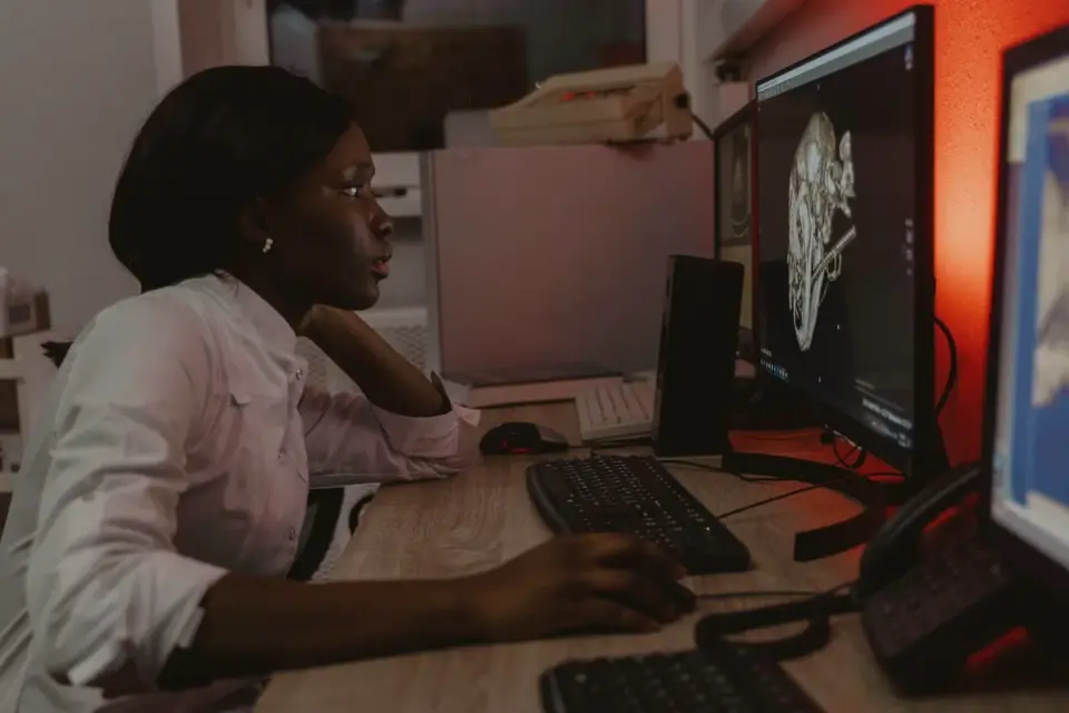A veterinarian reviewing canine bloodwork results on a desktop screen