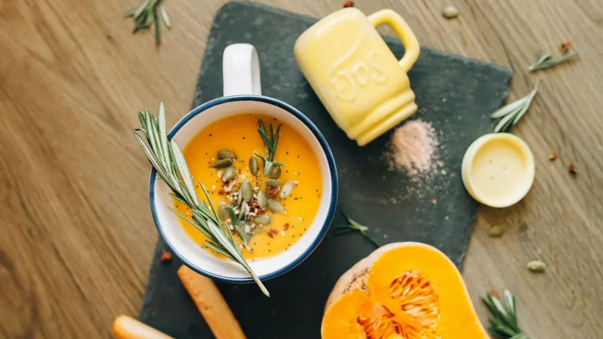 An open can of plain pumpkin puree beside a measuring scoop on a kitchen counter